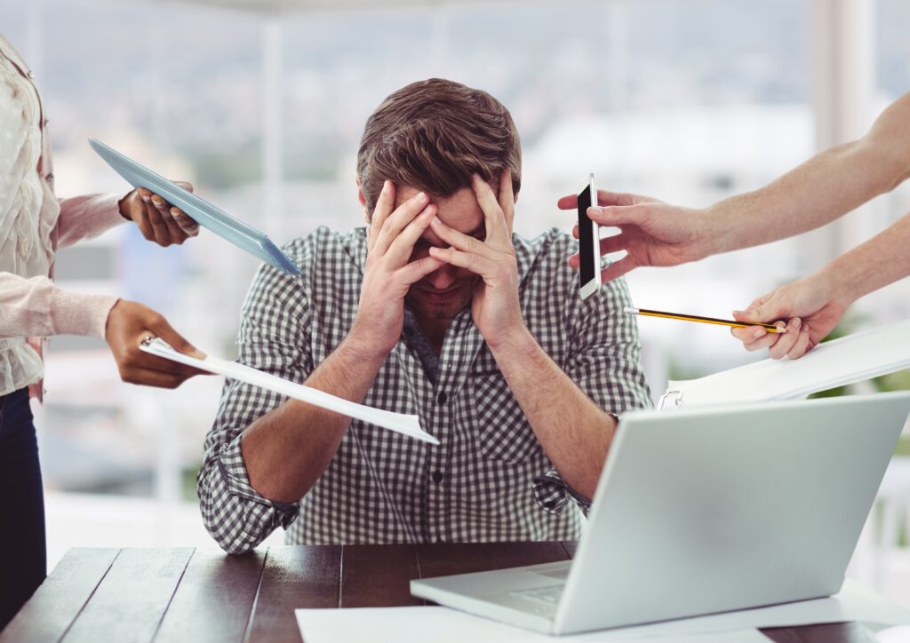 stressed man at desk. 